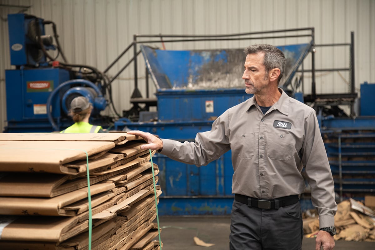 Man standing next to a flattened pallet of gaylord boxes