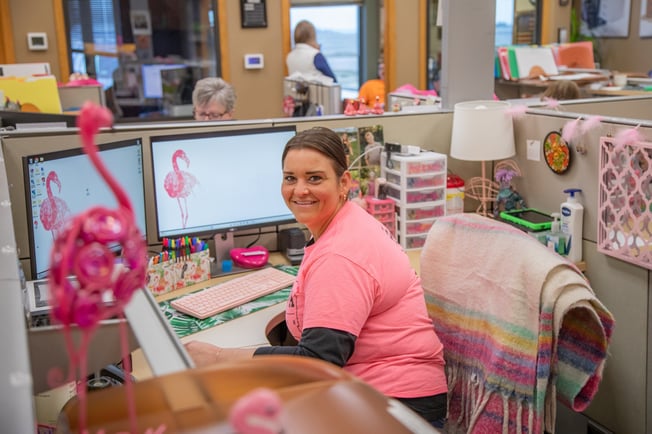 Woman sitting at her cubicle