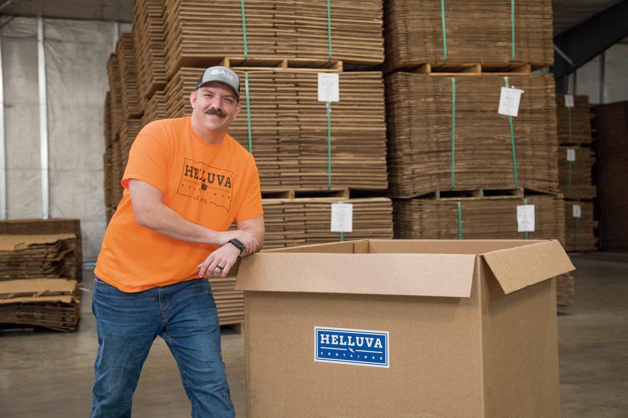 Man leaning against a Helluva Gaylord Box